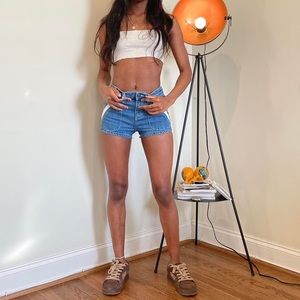 Medium wash daisy duke shorts by Free People